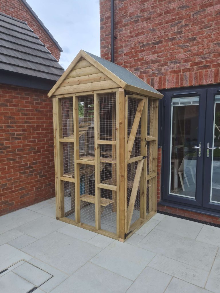 Wooden animal hut and outdoor pet enclosure in Staffordshire garden
