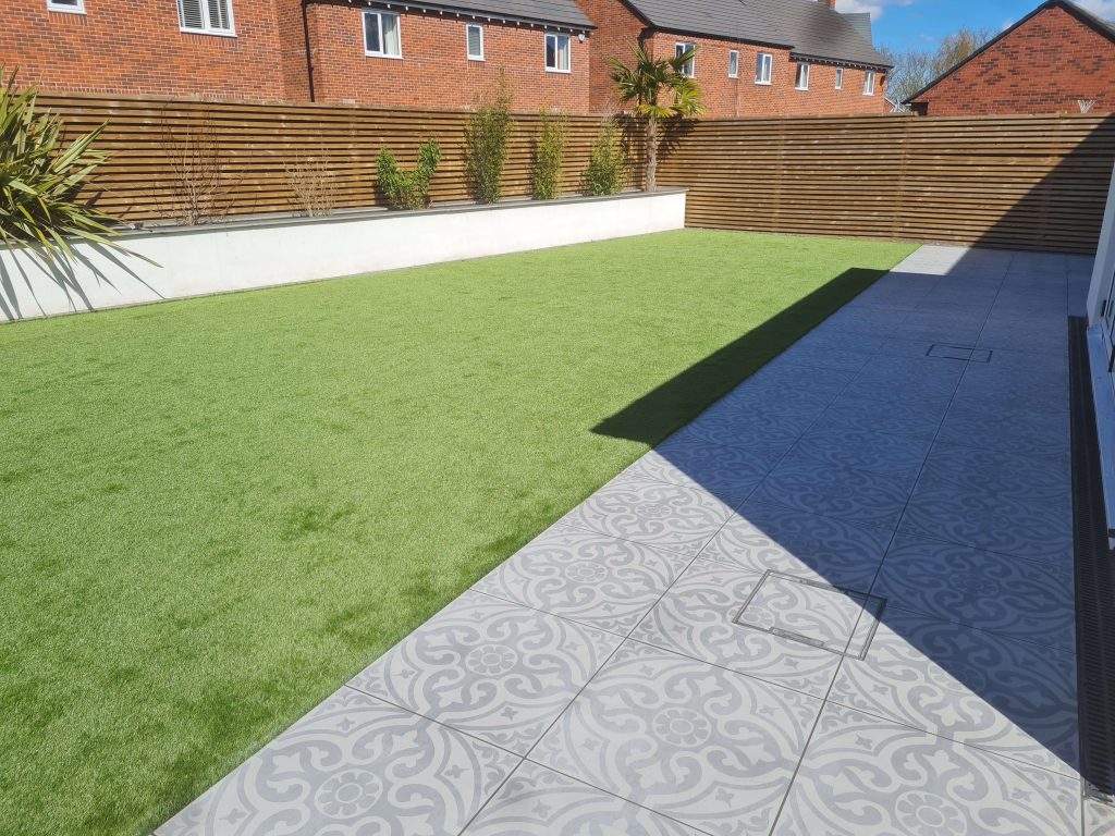 Artificial grass lawn and tiled patio garden in Staffordshire