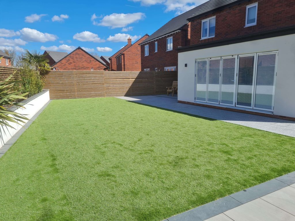Modern garden with artificial grass lawn and patio in Staffordshire