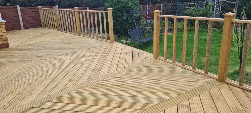 Raised timber garden decking with wooden balustrades in Staffordshire