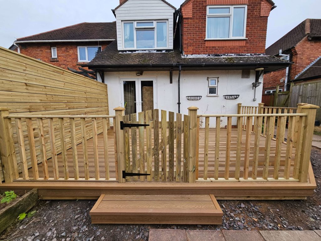 Raised garden decking with timber balustrades and gate in Staffordshire