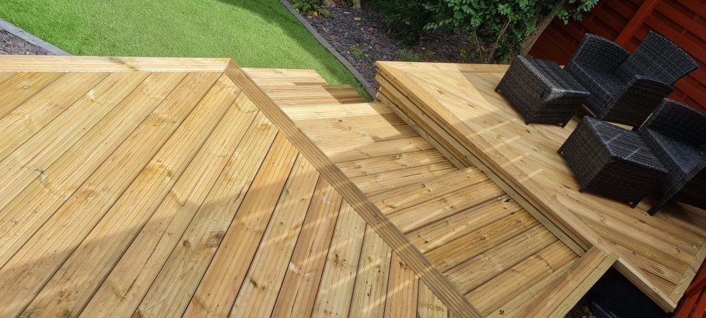 Raised timber decking with steps and seating area in Staffordshire