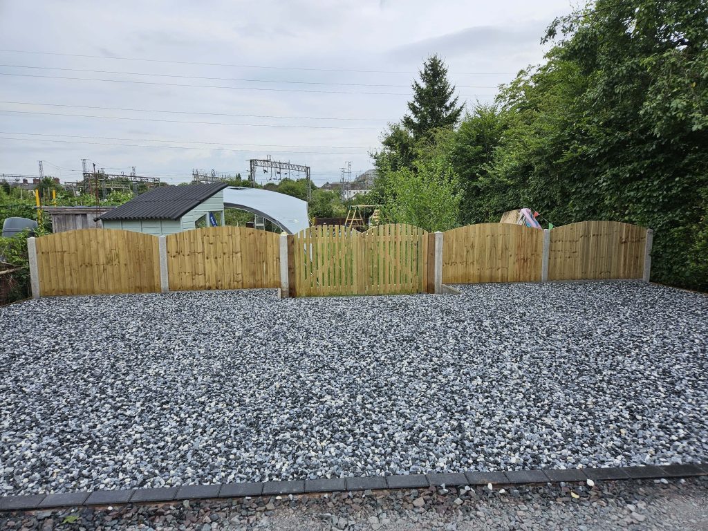 Gravel garden with timber fencing and wooden gate in Staffordshire