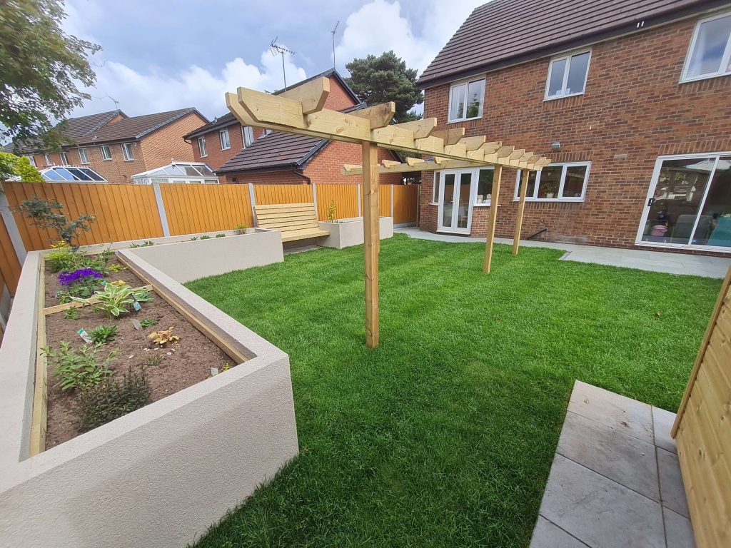 Landscaped garden with timber pergola, lawn and raised planters in Staffordshire