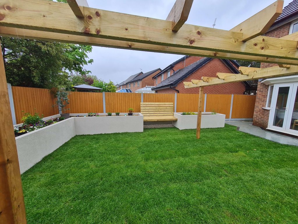 Landscaped garden with timber pergola, lawn and rendered planters in Staffordshire