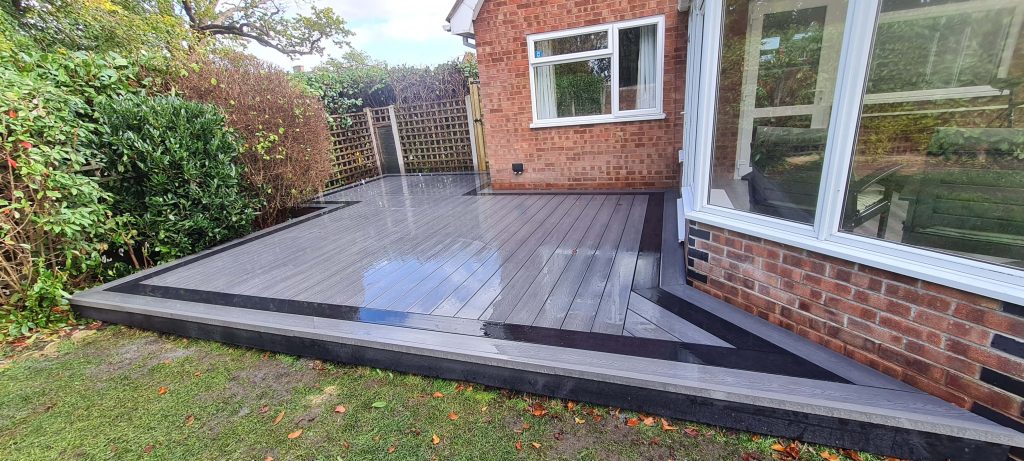 Grey composite garden decking beside house in Staffordshire